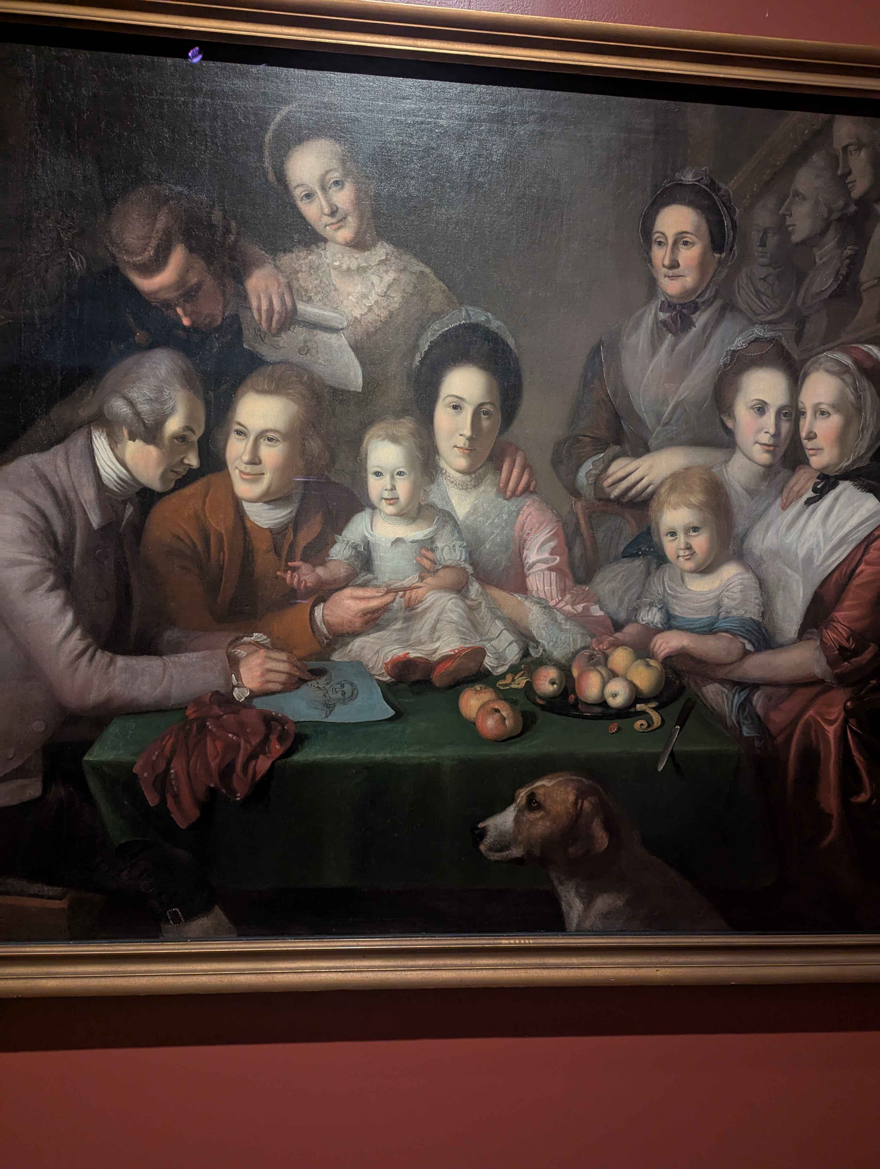 An old painting of a family with their pet dog.