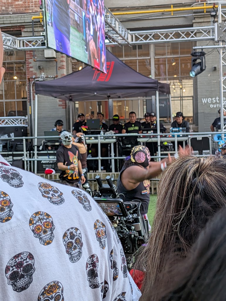 The ref is on the left with the green mask, and the other wrestler is on the right with the purple. He was the bad guy wrestler.