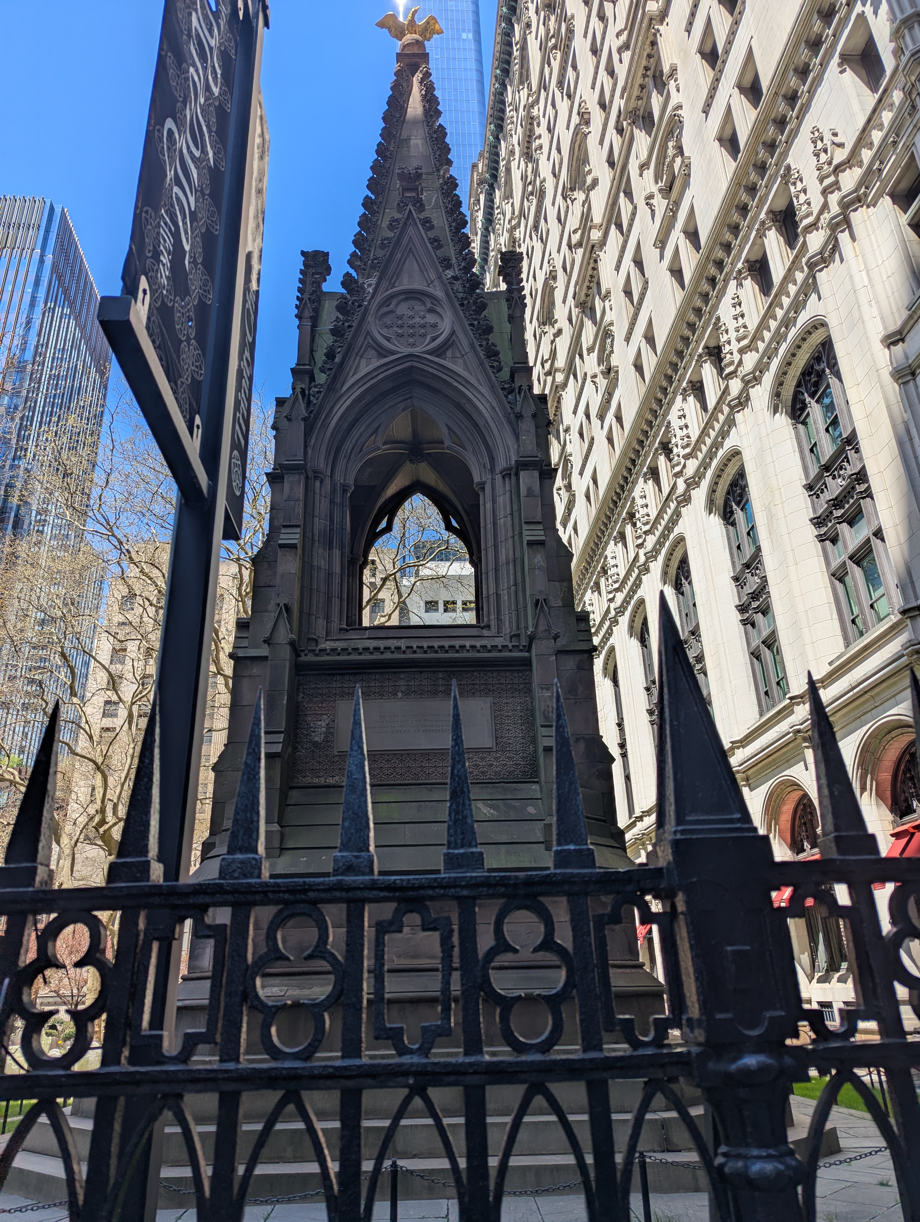 A cemetcemetaryery outside a church in the middle of Manhatten, the church is very beautiful and the cemetary is very old.