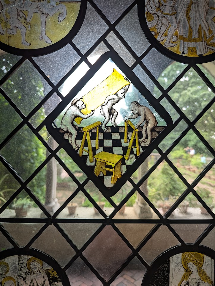 Just a stained glass window of some monkeys building a table.