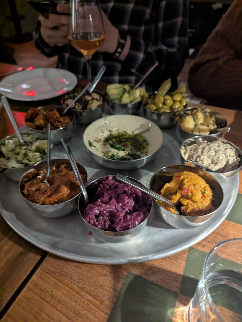 Shared side dishes at Laser Wolf. We dipped pita bread in all of this.
