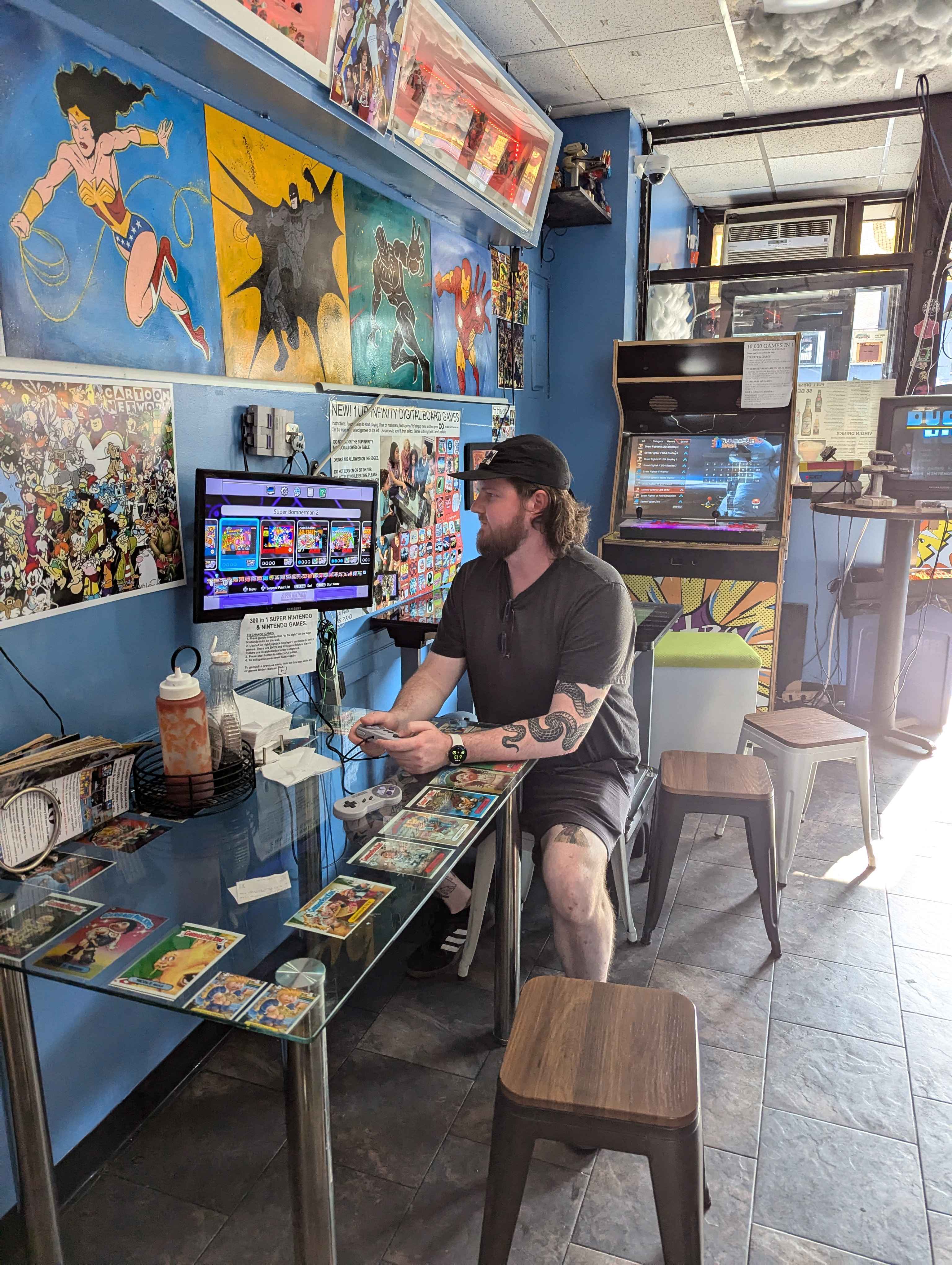 Jake playing video games at Action Burger.