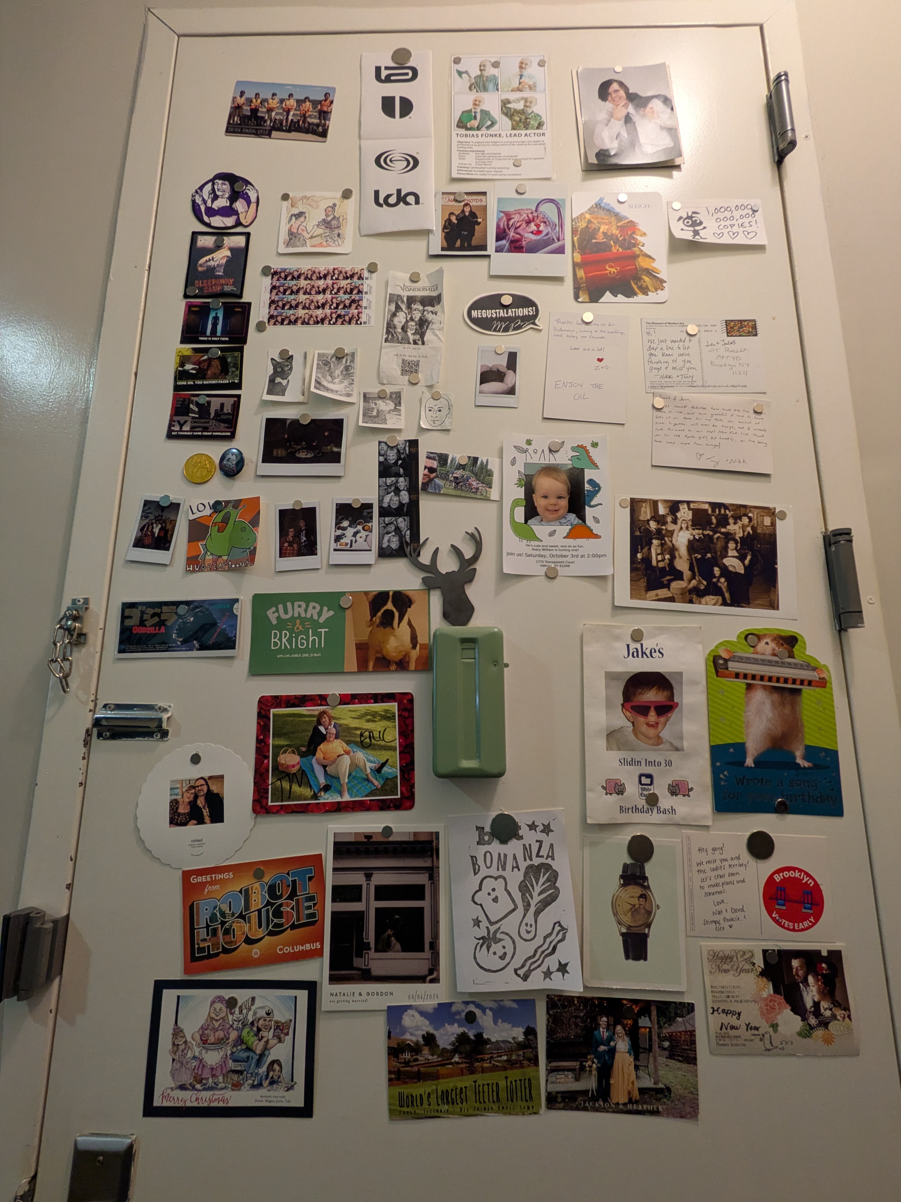 Our front door is metal, so we like to stick pictures and post cards and fun things on it