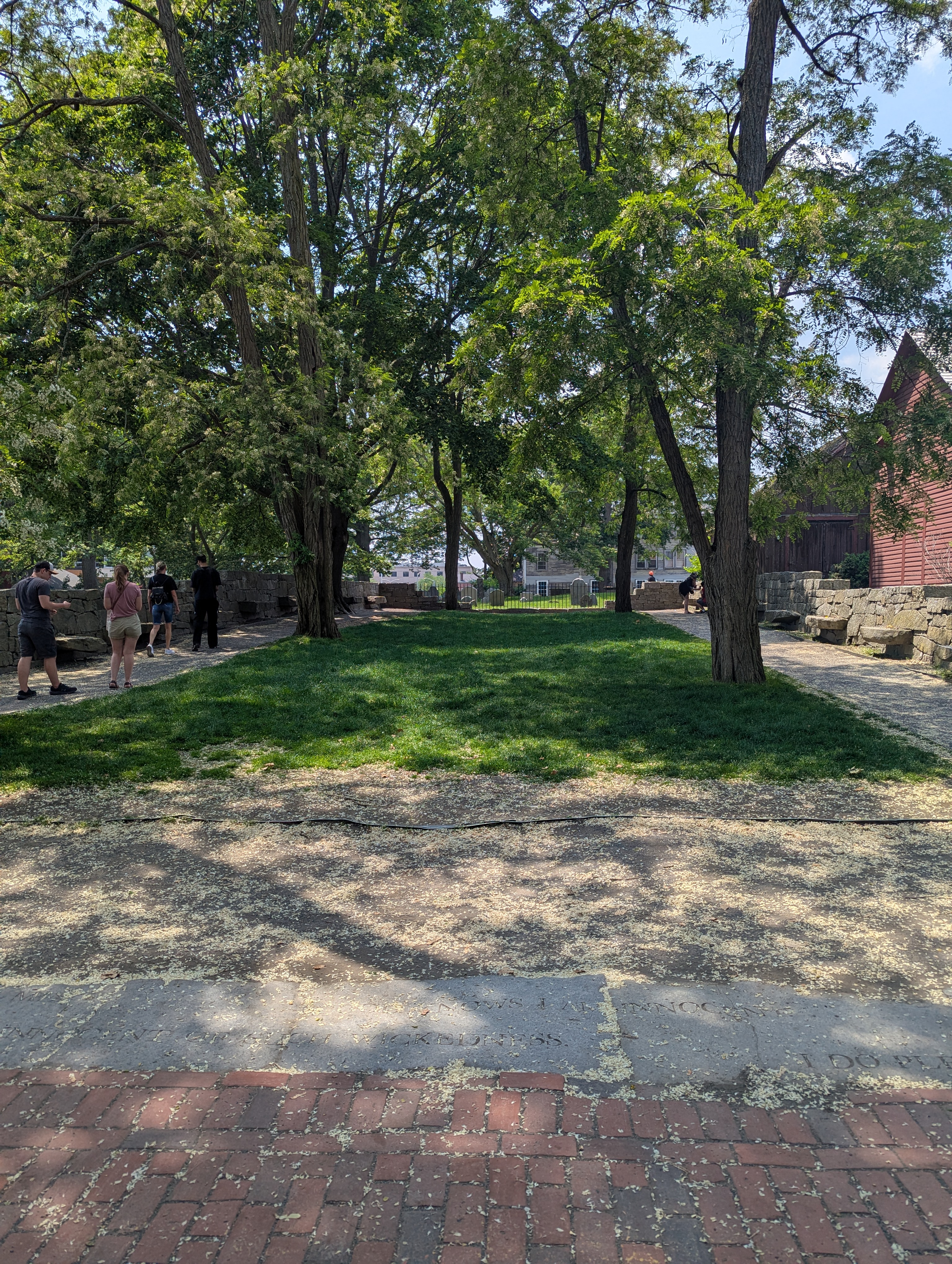 Outside the Charter Street Cemetery. The stones sticking out are monuments with the names of the victims of the witch trials.