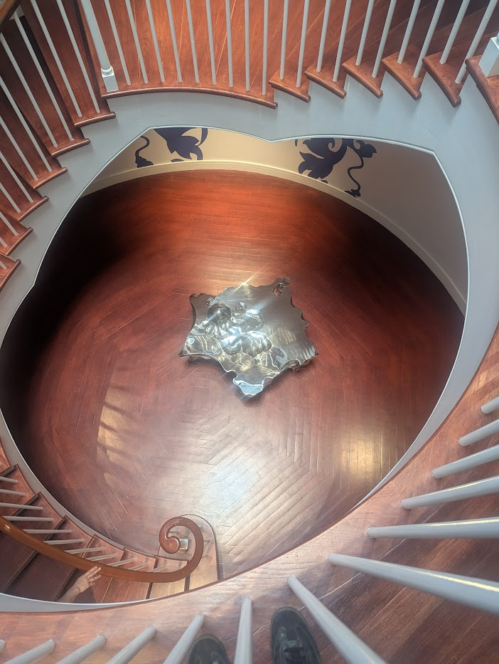 Some of the stairs leading down to a mirrored bench in the museum.