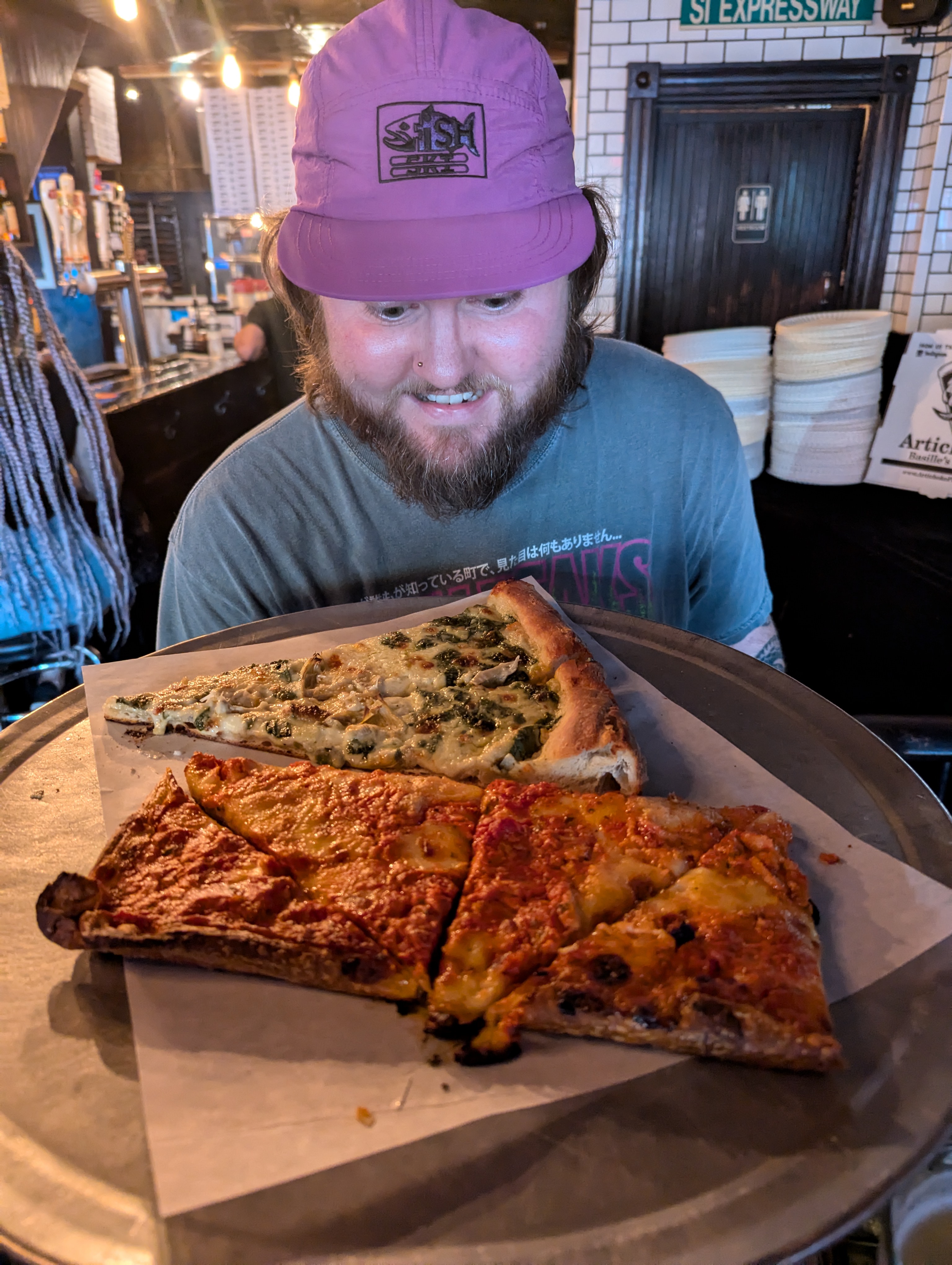 Jake loves pizza. This is at a popular place called Artichoke Basille. The pizza is really good!
